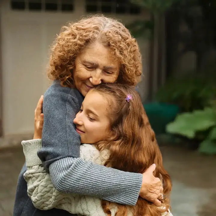 grandmother and granddaughter hug