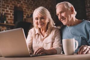 Seniors using laptop and connecting to the digital resources from Home Instead Toronto East